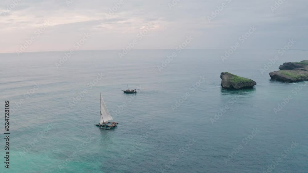 Fishing boats in Watamu Bay Beach at sunrise near Malindi, Kenya. Aerial drone view looking out to sea