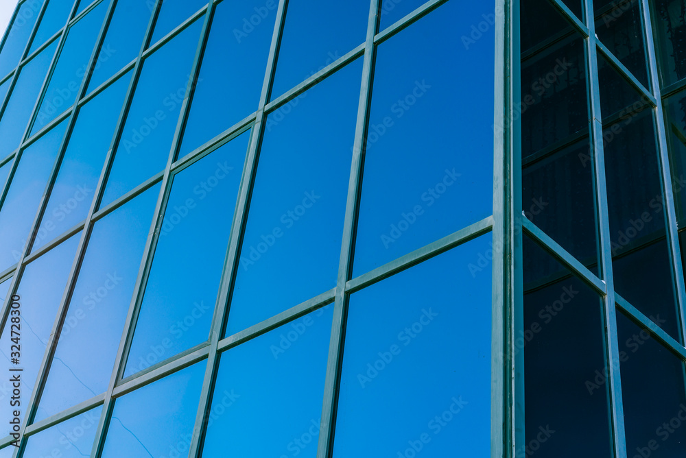 modern glass building. blue glass and concrete building for offices and businesses modern glass building. blue glass and concrete building for offices and businesses