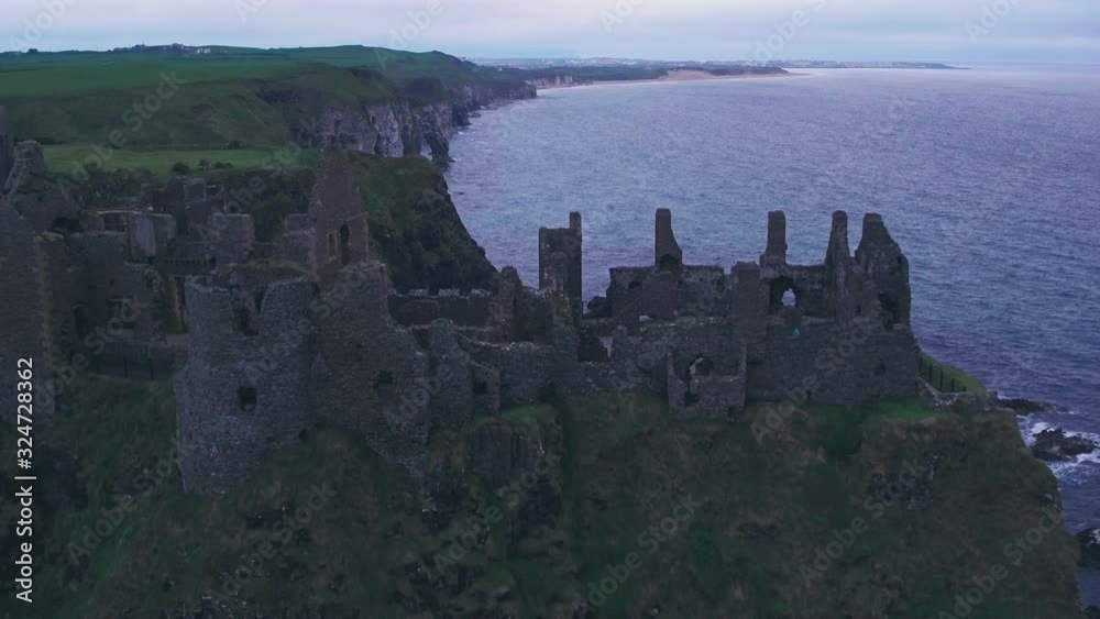 Dunluce Castle on the Antrim Coast, Northern Ireland. Aerial drone pull away Dunluce Castle on the Antrim Coast, Northern Ireland. Aerial drone pull away