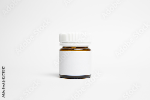 Glass Supplement Bottle & Box with blank label Mock up on light grey background. Mockup template ready for your design.Pills bottle.Top view.