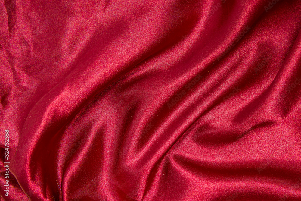 Red shiny fabric as a background. Red shiny fabric as a background.