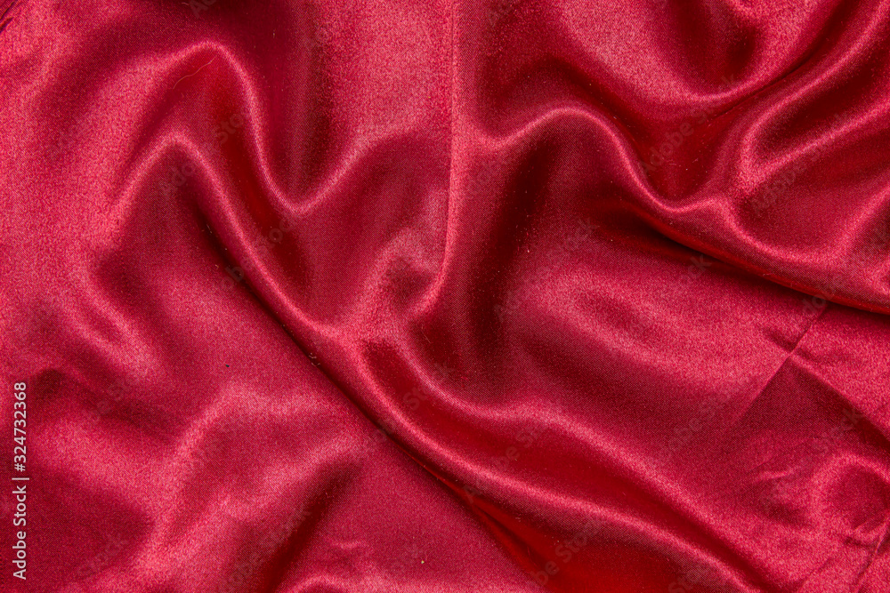 Red shiny fabric as a background. Red shiny fabric as a background.