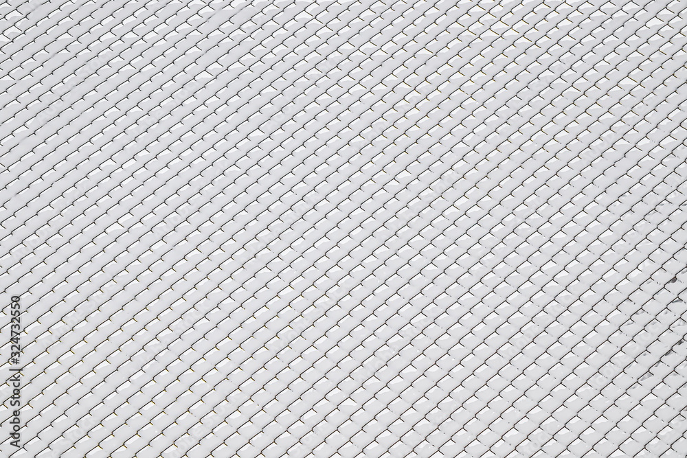 Snow on a metal mesh chain-link close-up as a background. Snow on a metal mesh chain-link close-up as a background.