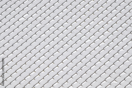 Snow on a metal mesh chain-link close-up as a background.