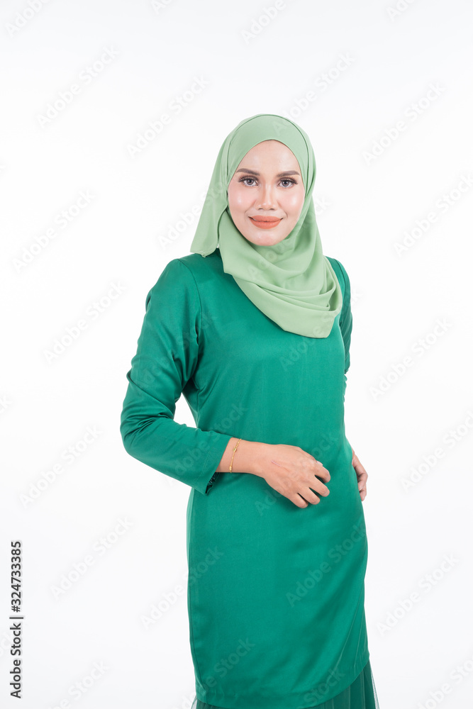 Beautiful female model in modern kurung and hijab, a modern lifestyle apparel for Muslim women isolated on white background. Beauty and hijab fashion concept. Half length portrait Beautiful female model in modern kurung and hijab, a modern lifestyle apparel for Muslim women isolated on white background. Beauty and hijab fashion concept. Half length portrait