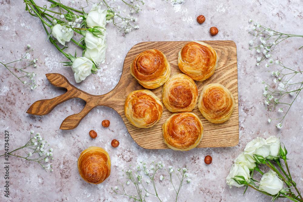Azerbaijan national pastry qogal on white plate on light background ,top view,spring new year celebration Novruz holiday. Azerbaijan national pastry qogal on white plate on light background ,top view,spring new year celebration Novruz holiday.