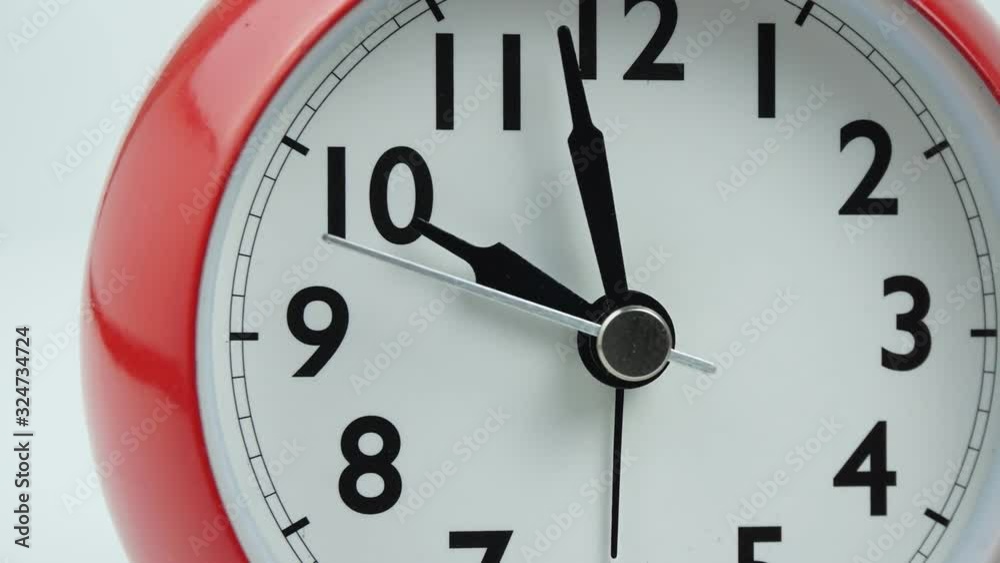 Move the camera angle from left to right, Red alarm clock beginning of time 09.10 run fast. Time passing 30 minutes. Time lapse moving fast on white background. Move the camera angle from left to right, Red alarm clock beginning of time 09.10 run fast. Time passing 30 minutes. Time lapse moving fast on white background.