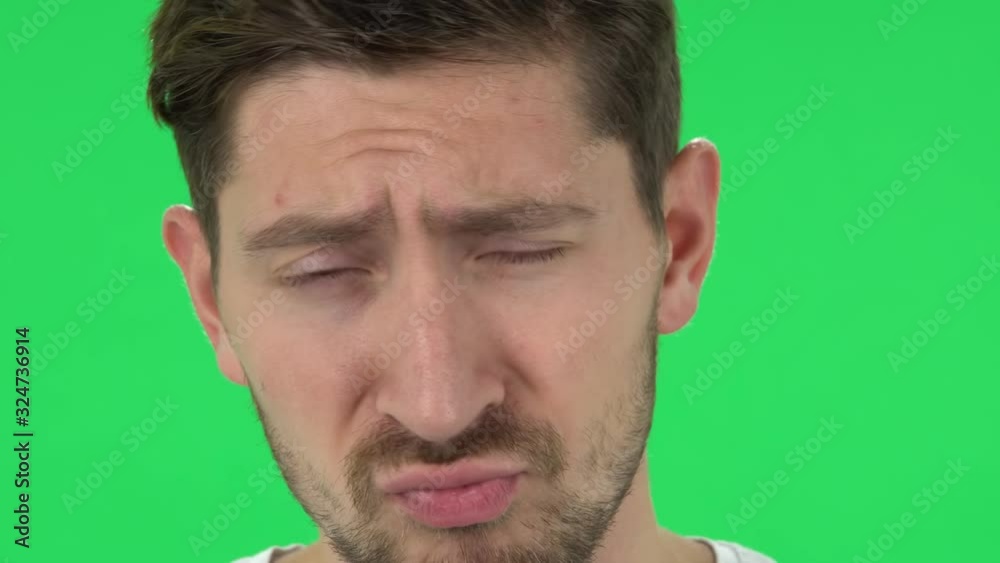 Man with a beard is smirking into camera. Close up. Green screen Man with a beard is smirking into camera. Close up. Green screen