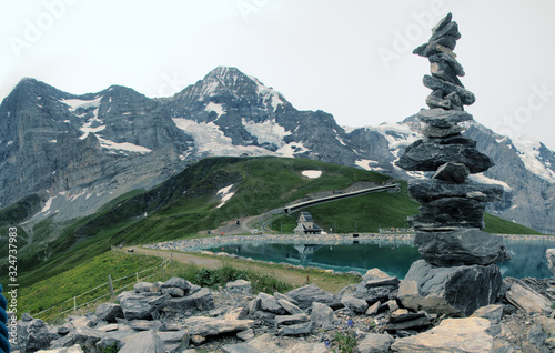 Artificial versus Natural Rock-stacking stacking by reservoir under the Three Sisters (Eiger, Jungfrau und Mönch) © elliottcb