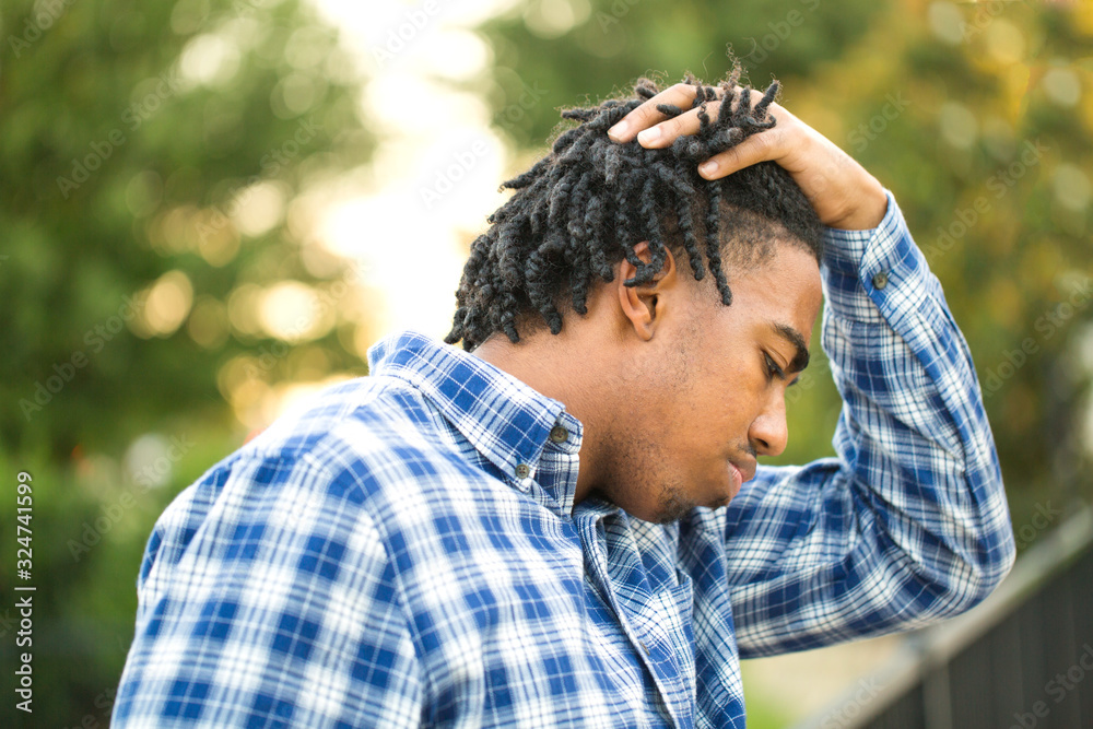 Young African American man in deep thought. Young African American man in deep thought.