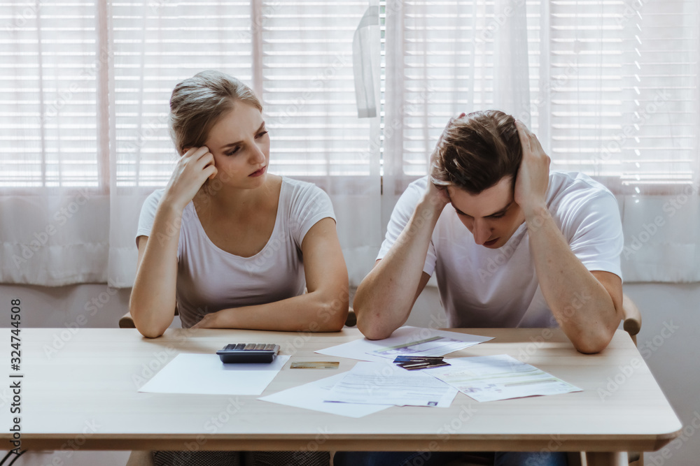 Fototapeta premium Stressed caucacian couple conflict of credit card bills or debt of over expense in shopping. Lover financial risk or crisis and bad habits of shopaholic. Lack of money discipline, planning and advisor