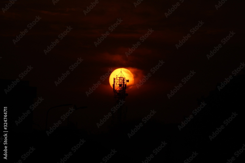 silhouette picture of cellphone tower on the sunset. sunset behind cellphone tower with red sky