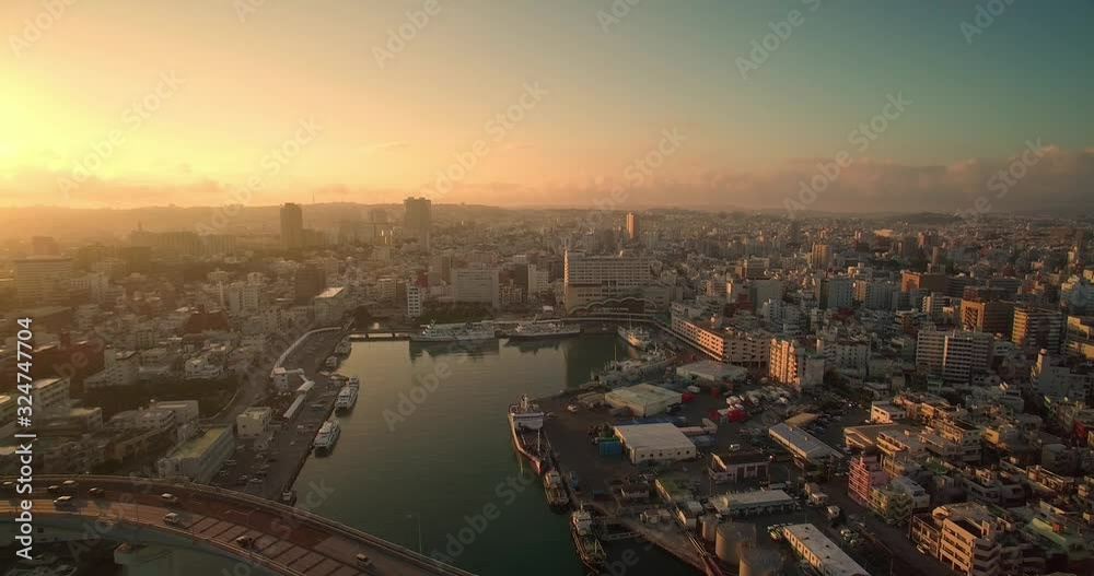 Aerial view of Naha city Okinawa Japan at sunrise with ocean views and Tomari port drone shot Aerial view of Naha city Okinawa Japan at sunrise with ocean views and Tomari port drone shot