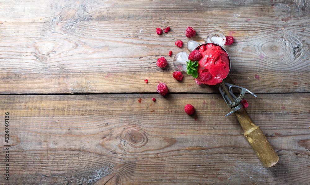 Raspberry sorbet, ice cream on a wooden background. Vintage ice cream spoon. Copy space. Raspberry sorbet, ice cream on a wooden background. Vintage ice cream spoon. Copy space.
