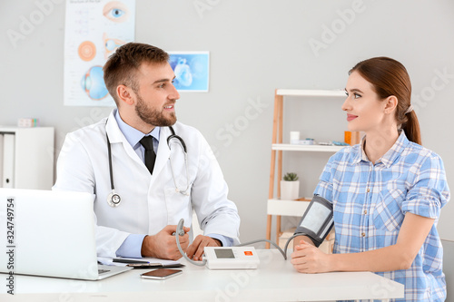 Male doctor measuring blood...