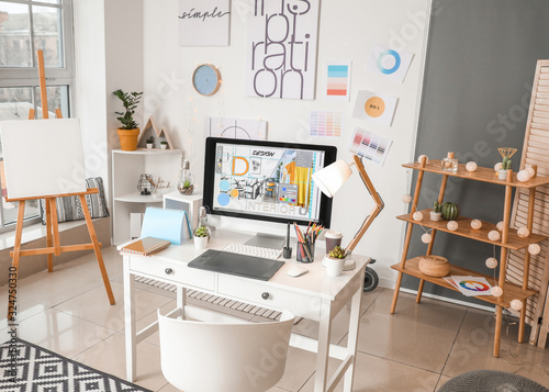 Interior of modern office with designer's workplace © Pixel-Shot