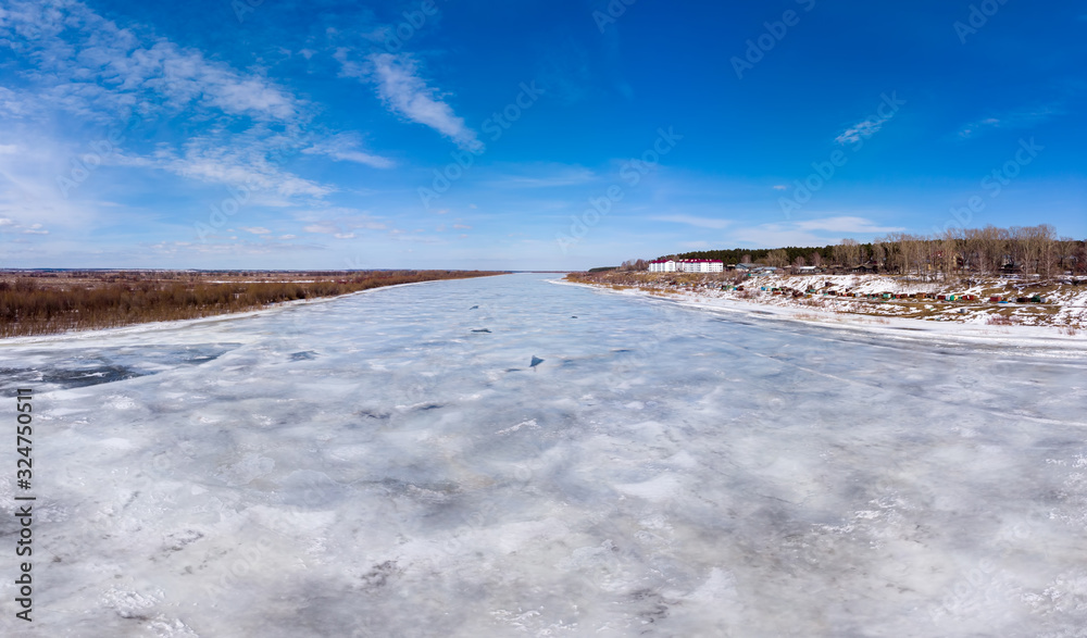 Icy surface of the river and blue sky