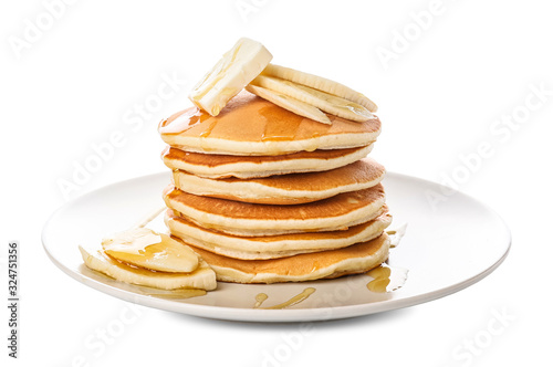 Tasty pancakes with honey, butter and banana on white background