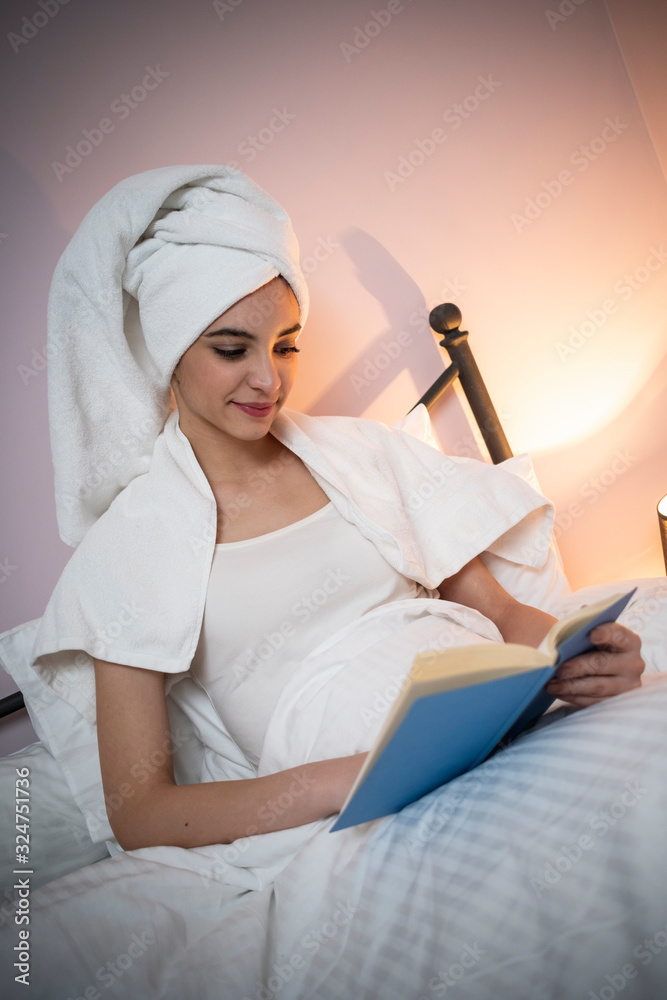 Beauty teenage girl having nice moments in bed and enjoying with book Beauty teenage girl having nice moments in bed and enjoying with book