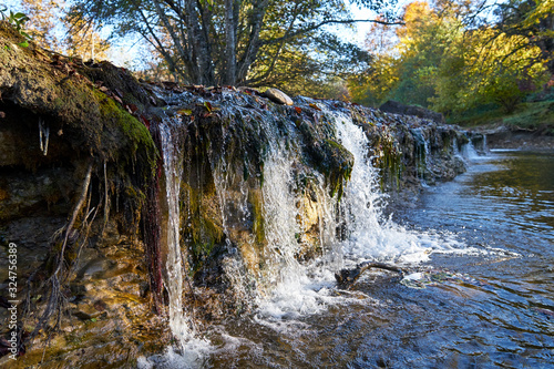 Image of an oil stain in a mountain stream.