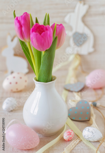 beautiful easter table decoration with  eggs ,rabbits and flowers in pastel colors