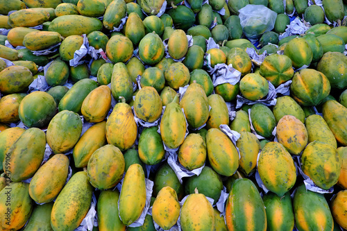 Many papaya fruits arrangement of floor for sale at outdoor farmer market