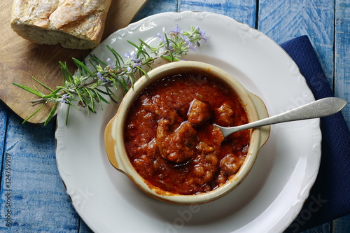 Magro o Magra de cerdo, con salsa de tomate regada con vino tinto photo