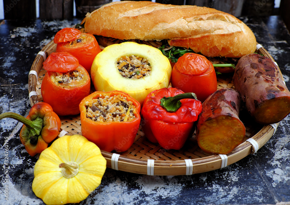 tray of vegan meal with grilled tomato, bell peppers,  pumpkin, sweet potato and bread