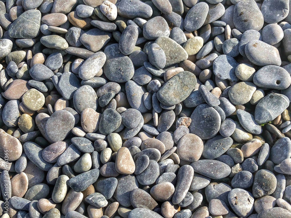 Pebbles on the beach. Abstract background with round pebbles stones Pebbles on the beach. Abstract background with round pebbles stones