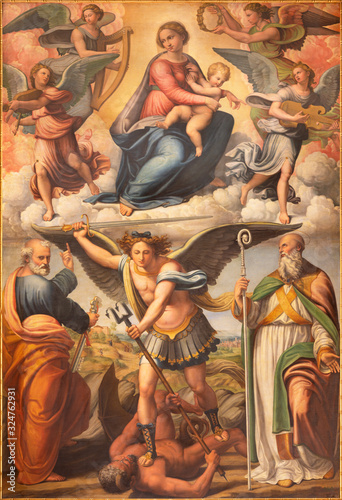 BOLOGNA, ITALY - FEBRUARY 3, 2020: The painting of Madonna with archangel Michael and the saints in church San Michele in Bosco by Innocenzo da Imola (1490 –1550).