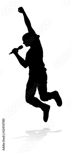 A singer pop, country music, rock star or hiphop rapper artist vocalist singing in silhouette