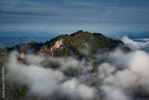 View of the mountain surrounded by cloud taken from Doi Pha Tang hill in Chiang Rai, Thailand.