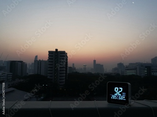 sensor detects unhealthy smog and bad Bangkok Thailand air quality. PM2.5 dust smog cover the urban skyline. Bad harmful unbreathable poisonous particles at hazardous level. photo