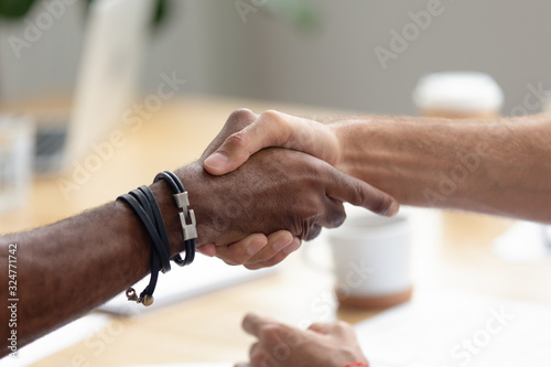 Close up African American businessman shaking hand of business partner