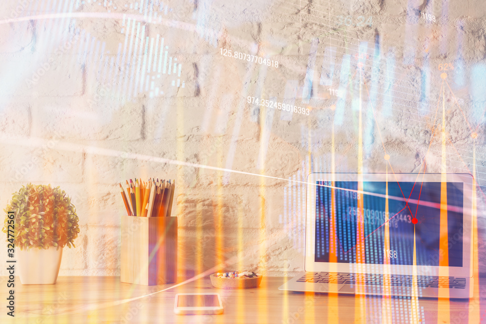 Naklejka premium Financial chart drawing and table with computer on background. Double exposure. Concept of international markets.