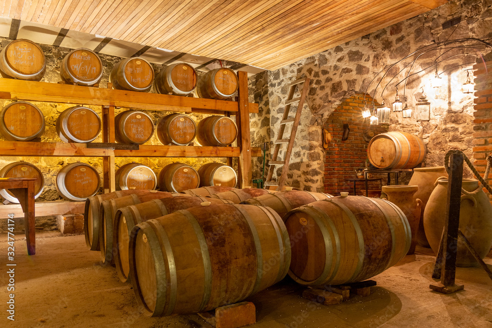 oak wine barrels in basement of winery oak wine barrels in basement of winery