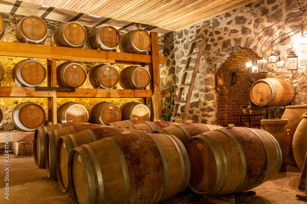 oak wine barrels in basement of winery
