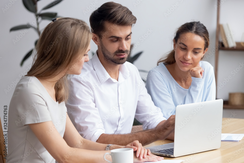 Confident businessman, mentor helping trainees with new software, staff training Confident businessman, mentor helping trainees with new software, staff training