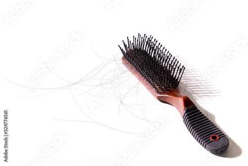 Hair comb brush with a lot of hair loss. on the White Blackground