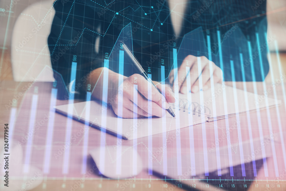 Forex graph on hand taking notes background. Concept of research. Multi exposure Forex graph on hand taking notes background. Concept of research. Multi exposure