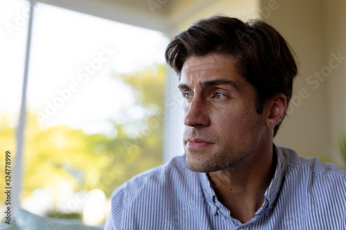 Young man at home looking away
