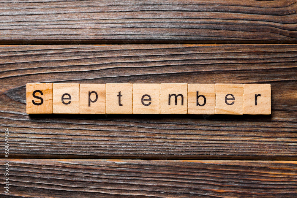 September word written on wood block. September text on wooden table for your desing, Top view concept