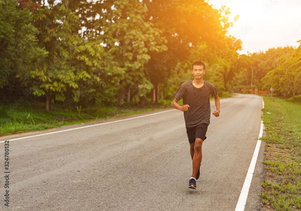  Young black runner man running on the street be exercise and workout in nature countryside road in the morning. Healthy body exercise sports concept.