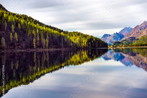 Mountain lake panorama with mountains reflection. Idyllic look. Autumn forest. Silvaplana Lake  Switzerland