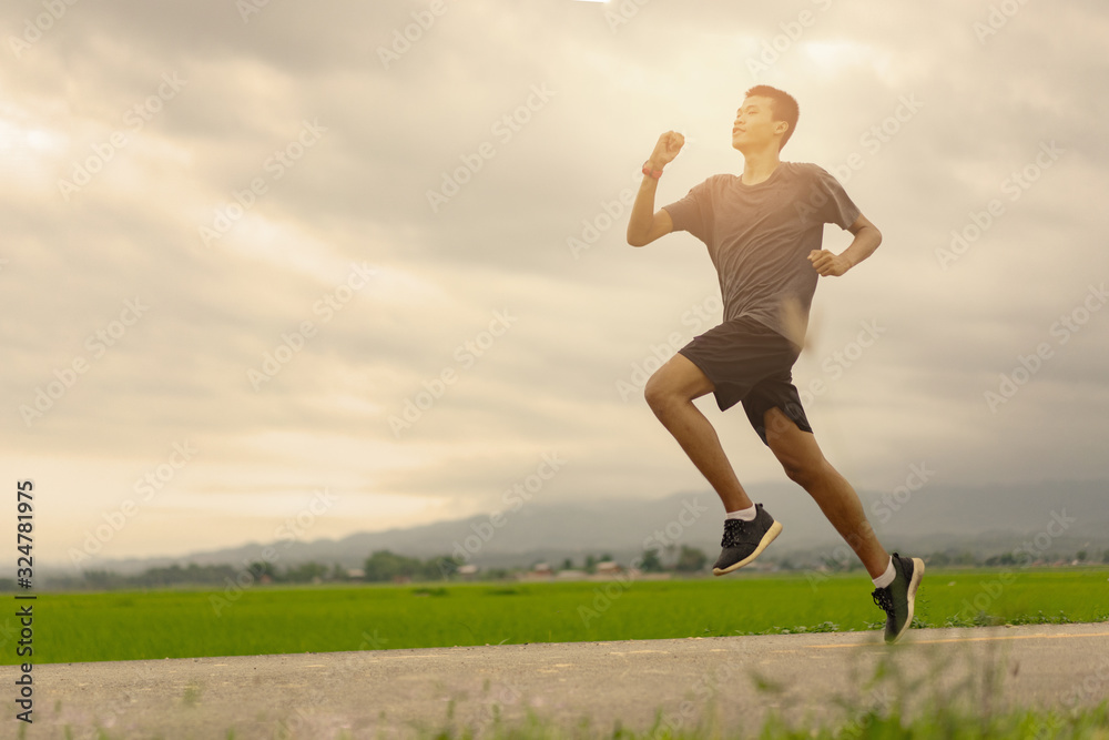  Young black runner man running on the street be exercise and workout in nature countryside road in the morning. Healthy body exercise sports concept.