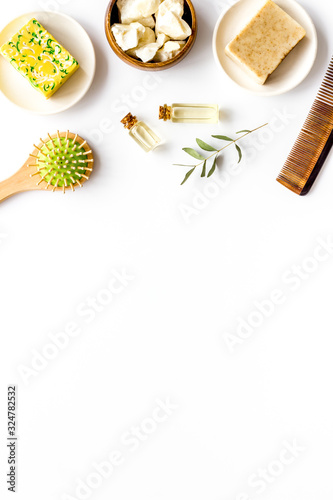 Hair care concept. Coconut oil, brush on white background top-down frame copy space