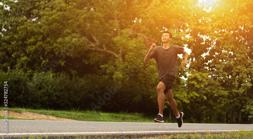 Young black runner man running on the street be exercise and workout in nature countryside road in the morning. Healthy body exercise sports concept. for banner website