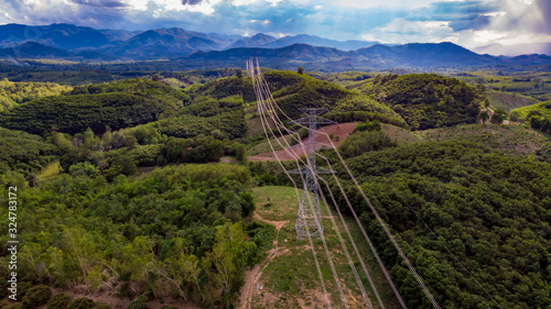 Obraz na plátně electric pole high voltage towers with green tree forrest ,aerial drone view