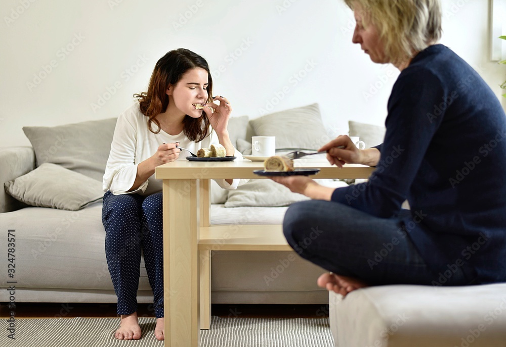 two women are talking and eating two women are talking and eating
