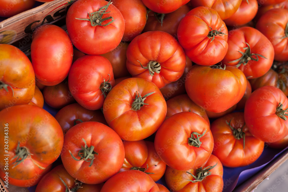 fresh tomatoes on branch in wicker baskets on counter fresh tomatoes on branch in wicker baskets on counter